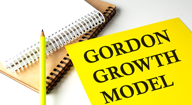 GORDON GROWTH MODEL text on yellow paper with notebooks