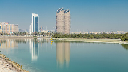 Fototapeta premium View of skyscrapers skyline with Al Bahr towers in Abu Dhabi timelapse. United Arab Emirates