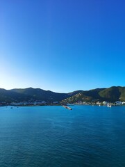 coast at caribbean island with boats and buildings