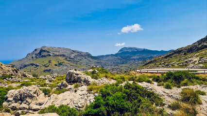 Wide angle of the scenic beauty of Serra de Tramuntana peak reaching out to the clouds in Mallorca - obrazy, fototapety, plakaty