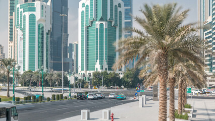 Fototapeta na wymiar The high-rise district of Doha with traffic on intersection timelapse