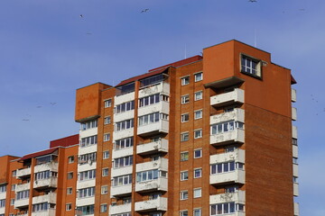 Fototapeta premium Looking up to red (orange) brick with many windows, Lasnamae, Tallinn, Estonia, Europe. 2024