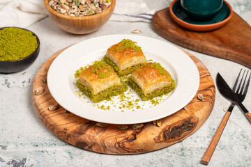 Baklava with pistachios on a wooden background. Turkish cuisine delicacies. Ramadan Dessert. local...