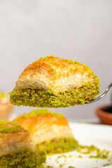 Baklava with pistachios on a wooden background. Turkish cuisine delicacies. Ramadan Dessert. local name kuru baklava
