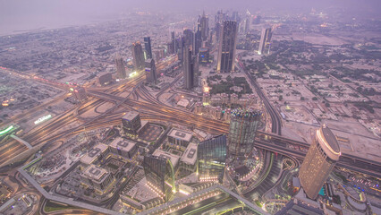 Fototapeta na wymiar Dubai downtown day to night transition with city lights from above timelapse