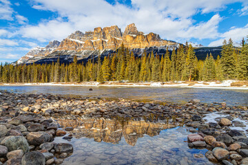 Castle Mountain in Banff National Park, Canada, with reflection on puddle along the Bow River
