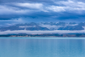 Obraz premium Photograph of Lake Tekapo in the early morning with snow-capped mountains in the background on the South Island of New Zealand
