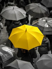 Gray gloomy dark day, rainy weather, everything is black and depressing, the only bright spot is a yellow umbrella, a color in the darkness.