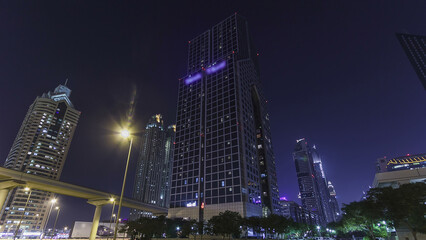 Fototapeta na wymiar Skyscrapers at the Sheikh Zayed Road night in Dubai timelapse hyperlapse