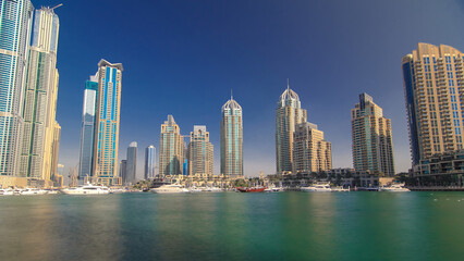 Obraz premium Dubai Marina with tallest skyscrapers and boats timelapse hyperlapse