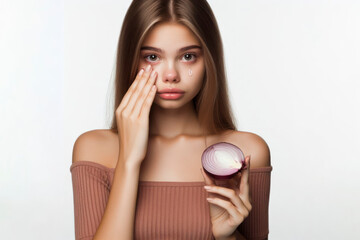 A girl holds a slice onion near her face with small tears in her eyes isolated on white background. ai generative