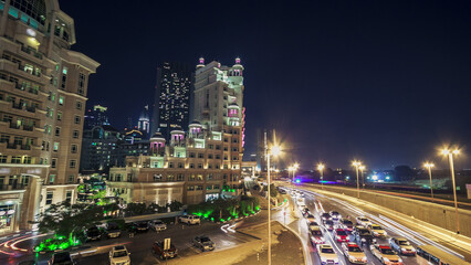 Fototapeta na wymiar Moving cars traffic on night road in modern city Dubai timelapse hyperlapse
