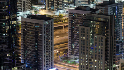 Fototapeta na wymiar Dubai Marina towers night aerial timelapse