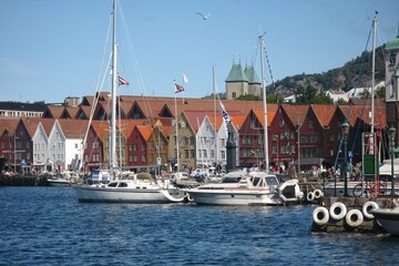 Panoramic view of Bryggen harbor and embankment with yachts in historic downtown district at summer...