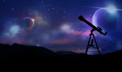 Silhouette of telescope in mountains at night