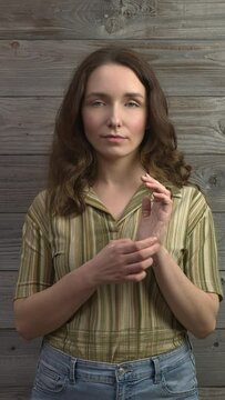 Person practicing EFT. Female tapping side of the hand, karate chop (KC) meridian point. Vertical video.
