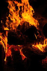 Tongues of flame. Red orange bonfire black background. Danger Uncontrolled force. attractive fire. Summer camping. Close up Bright light
