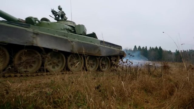 A Russian T72 tank is driving along a country road. War in Ukraine. Russian aggression in Ukraine