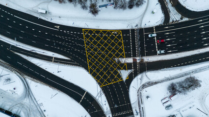 Drone photography of top down view multiple lane roads interchanging during winter day