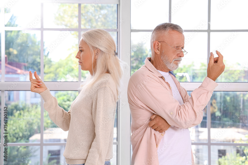 Canvas Prints upset mature couple with wedding rings at home. divorce concept