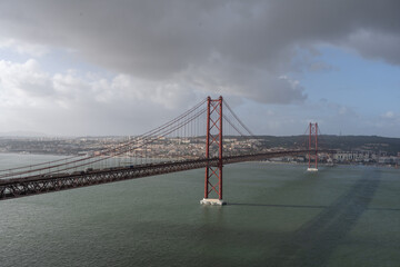 The 25 Aprile bridge is a suspension bridge over the Tagus River estuary - 756730364