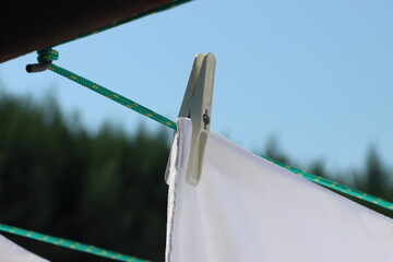 white bed linen hanging outside on a line