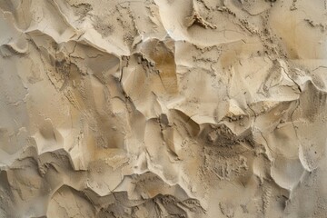 Close-up of a wall covered in sand. Suitable for backgrounds or textures