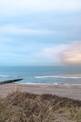 Fototapeta na wymiar Beach near Domburg town in spring fresh morning with cloudy sky