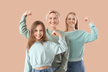 Keuken spatwand met foto Little girl with her mom and grandmother showing muscles on beige background © Pixel-Shot