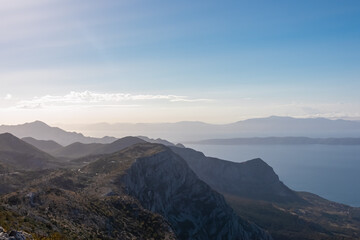 Obraz premium Panoramic aerial view of the Makarska Riviera seen from skywalk in Biokovo nature park, Dalmatia, Croatia. Majestic karst coastline of Adriatic Mediterranean sea in summer. Tranquil serene atmosphere