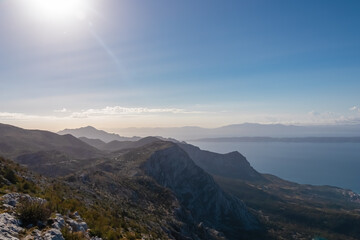 Fototapeta premium Panoramic aerial view of the Makarska Riviera seen from skywalk in Biokovo nature park, Dalmatia, Croatia. Majestic karst coastline of Adriatic Mediterranean sea in summer. Tranquil serene atmosphere