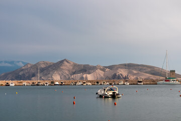 Panoramic view of small boats in port in coastal town Baska, Krk Island, Primorje-Gorski Kotar, Croatia, Europe. Scenic view of majestic coastline of Mediterranean Adriatic Sea in summer. Tranquility