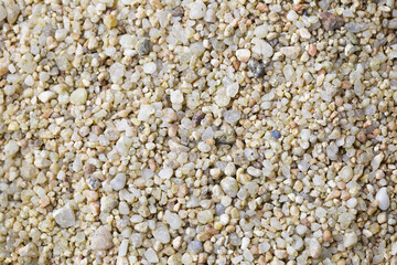 Flat texture of a pile of sand with small rocks and pebbles. Top view