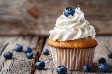 Tasty cupcake with butter cream and ripe blueberries on wooden table - obrazy, fototapety, plakaty