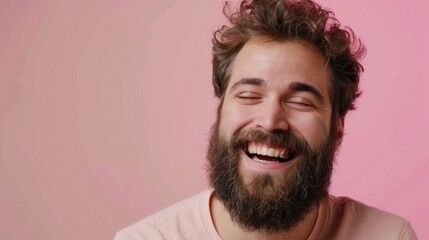 Obraz premium A man with a beard smiles while holding a donut. Suitable for food and lifestyle concepts