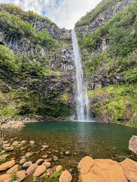 Scenic view of majestic waterfall Cascata Risco along idyllic Levada walk 25 fountains in evergreen subtropical Laurissilva forest of Rabacal, Madeira island, Portugal, Europe. Plunge pool below