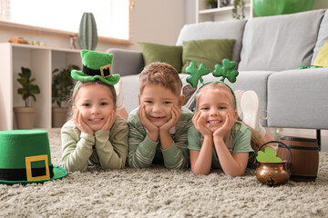 Cute kids celebrating St. Patrick's Day with festive green outfits at home party