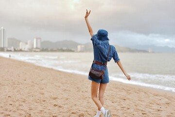 Serene Solitude: A Young, Attractive Caucasian Female Enjoying the Sunny Beach Vacation, Walking...