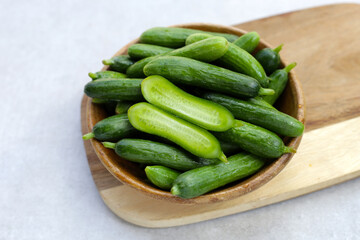 Fresh mini cucumbers in bowl
