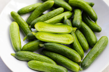 Fresh mini cucumbers in bowl