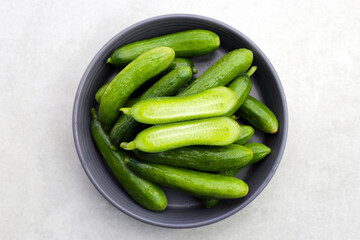 Fresh mini cucumbers in bowl