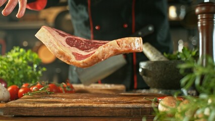 Chef Throwing Raw Beef Steak on Wooden Cutting Board. - 756775351