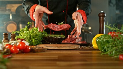 Chef Throwing Raw Beef Steak on Wooden Cutting Board. - 756775370