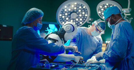 Robot performs operation on patient together with experienced specialists. Professional medical...