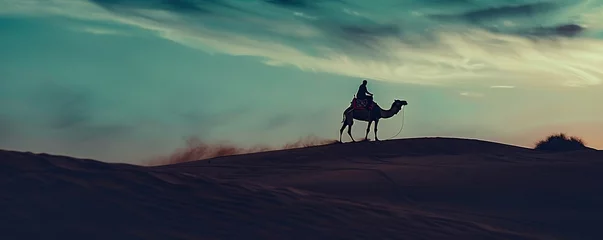 Fotobehang riding a camel in the desert © subhan