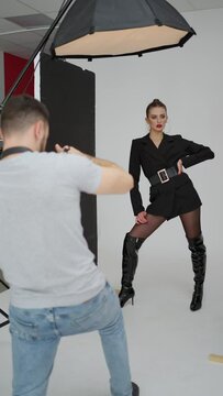 Dynamic Fashion Photoshoot in Action. Photographer capturing a commanding model pose during a fashion shoot. Concept Fashion Photography, Action, Professionalism