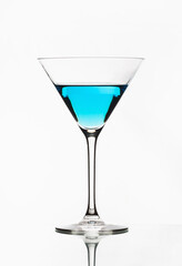Blue cocktail isolated on white. One blue cocktail martini isolated. 