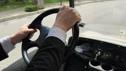 Pov driving golf cart on road in park