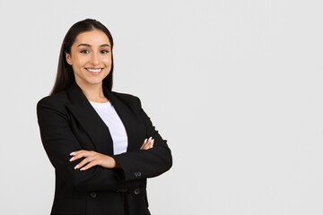 Confident professional woman in black suit smiling