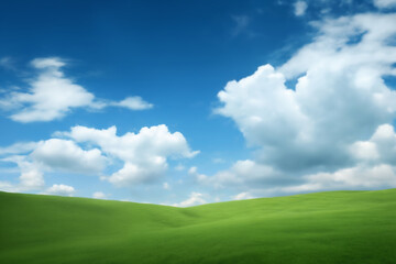 Fototapeta premium A beautiful summer landscape as a background, with green grass on the hills and green fields. The blue sky is filled with white clouds and bright sunlight, beautiful nature